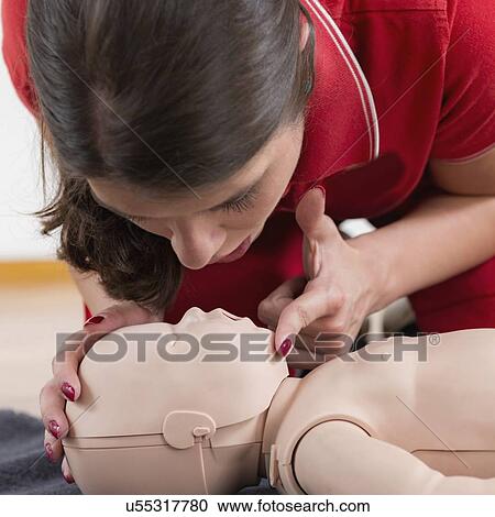 Stock Image - Infant cardiopulmonary resuscitation training. Fotosearch