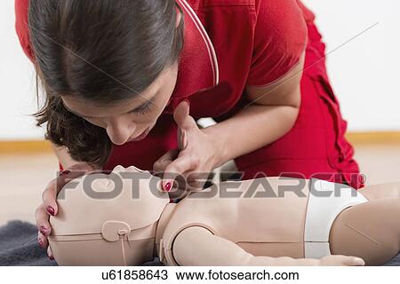 Stock Image - Infant cardiopulmonary resuscitation training. Fotosearch