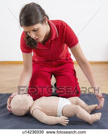 Stock Photo - Infant cardiopulmonary resuscitation training. Fotosearch