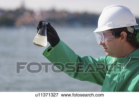 Inspector with sample of polluted water View Large Photo Image Stock Photo - Inspector with sample of polluted water. Fotosearch