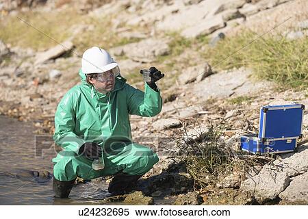 Stock Photography - Inspector with samples of polluted water. Fotosearch