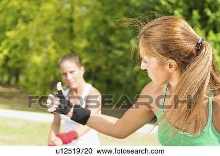 Stock Image - Kickboxing training outdoors. Fotosearch