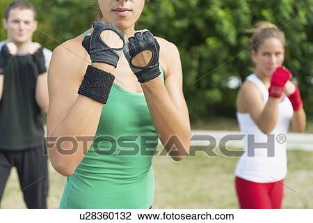 Stock Image - Kickboxing training outdoors. Fotosearch