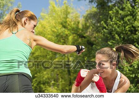 Stock Image - Kickboxing training outdoors. Fotosearch