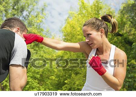 Stock Photo - Kickboxing training outdoors. Fotosearch