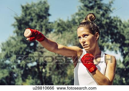 Stock Photograph - Kickboxing training outdoors. Fotosearch