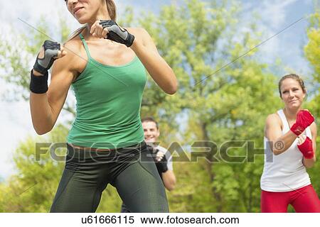 Stock Photography - Kickboxing training outdoors. Fotosearch