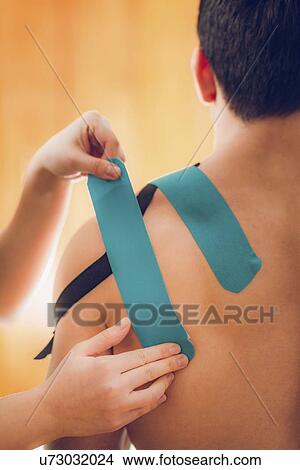 Picture - Kinesio tape application. Fotosearch
