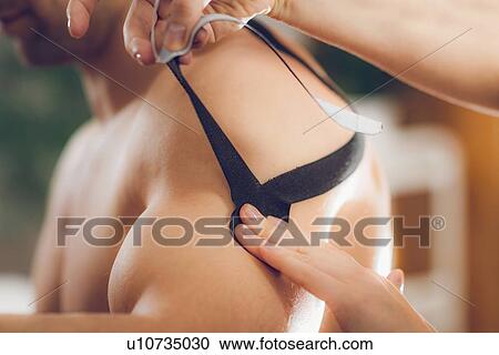 Stock Image - Kinesio tape application. Fotosearch