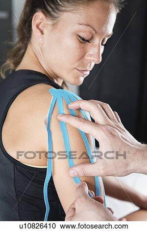 Stock Image - Kinesio tape application. Fotosearch