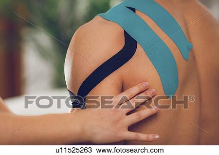 Stock Image - Kinesio tape application. Fotosearch