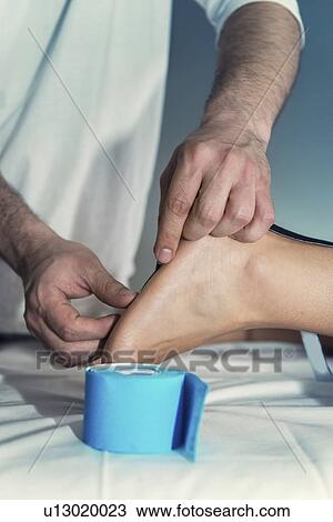 Stock Image - Kinesio tape application. Fotosearch
