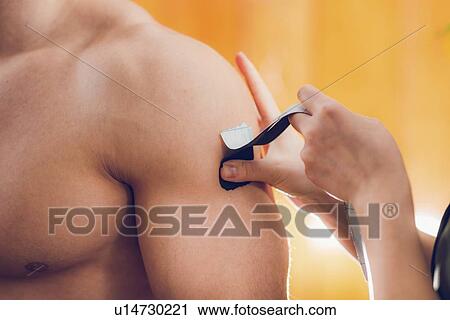 Stock Image - Kinesio tape application. Fotosearch