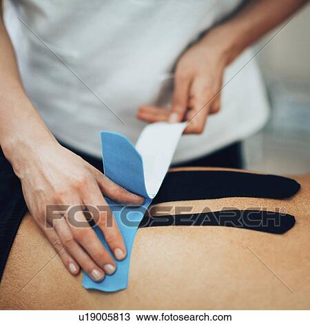 Stock Image - Kinesio tape application. Fotosearch