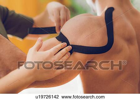 Stock Image - Kinesio tape application. Fotosearch