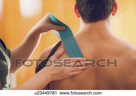 Stock Image - Kinesio tape application. Fotosearch