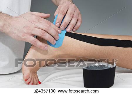 Kinesio tape application View Large Photo Image Stock Image - Kinesio tape application. Fotosearch