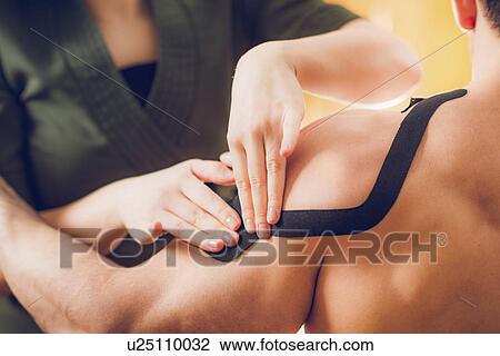 Stock Image - Kinesio tape application. Fotosearch