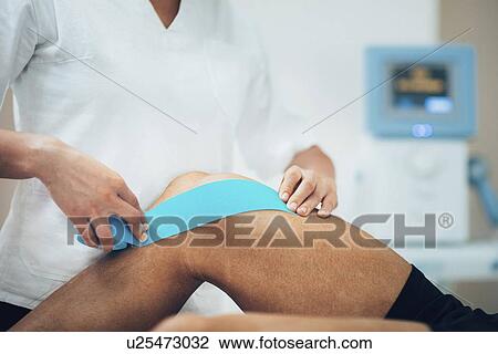 Stock Image - Kinesio tape application. Fotosearch