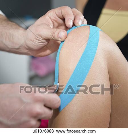 Stock Image - Kinesio tape application. Fotosearch