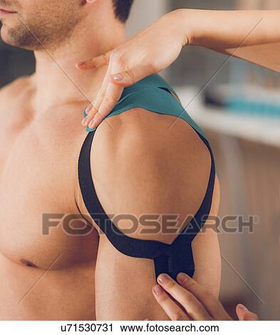 Stock Image - Kinesio tape application. Fotosearch