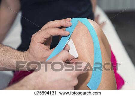 Stock Image - Kinesio tape application. Fotosearch