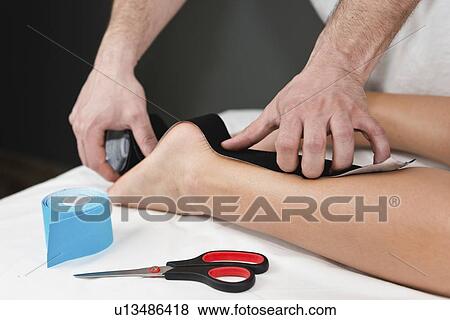 Kinesio tape application View Large Photo Image Stock Photo - Kinesio tape application. Fotosearch