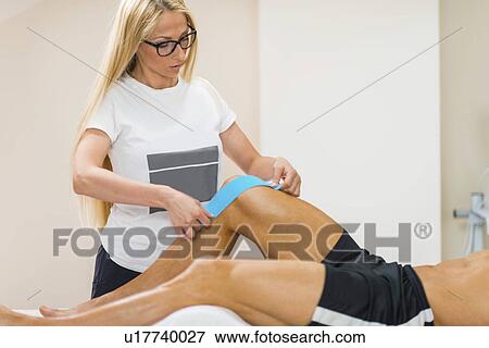 Kinesio tape application View Large Photo Image Stock Photo - Kinesio tape application. Fotosearch