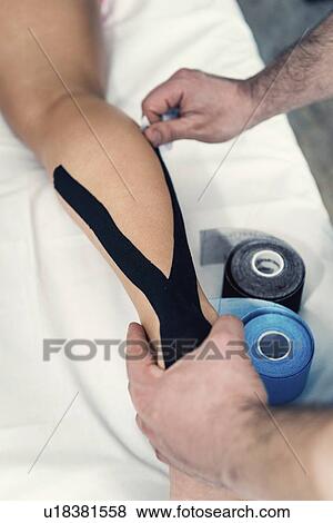 Kinesio tape application View Large Photo Image Stock Photo - Kinesio tape application. Fotosearch