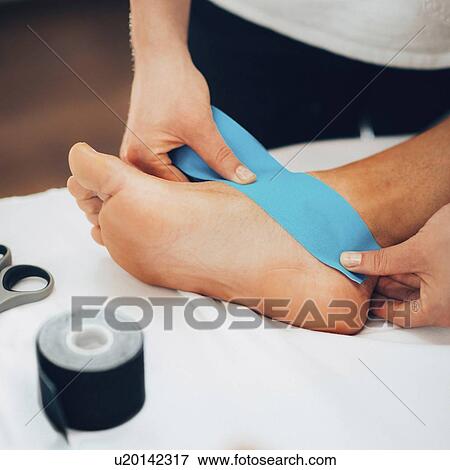 Stock Photo - Kinesio tape application. Fotosearch