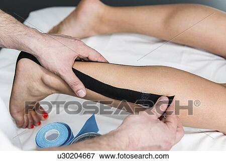 Stock Photo - Kinesio tape application. Fotosearch