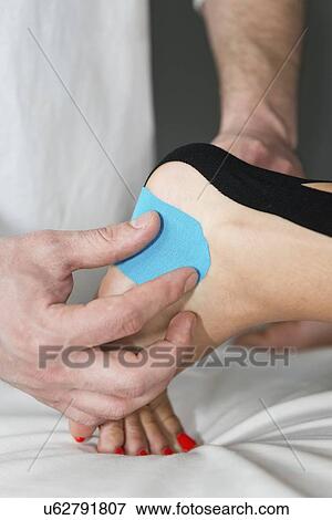 Kinesio tape application View Large Photo Image Stock Photo - Kinesio tape application. Fotosearch
