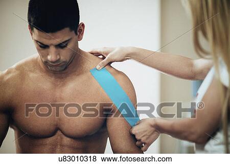 Kinesio tape application View Large Photo Image Stock Photo - Kinesio tape application. Fotosearch