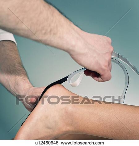 Stock Photograph - Kinesio tape application. Fotosearch