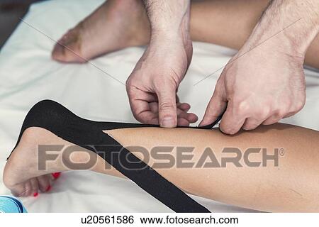 Kinesio tape application View Large Photo Image Stock Photograph - Kinesio tape application. Fotosearch