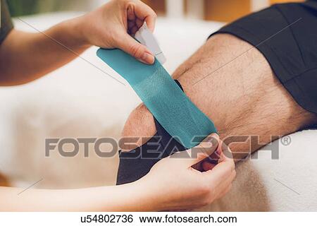 Stock Photograph - Kinesio tape application. Fotosearch