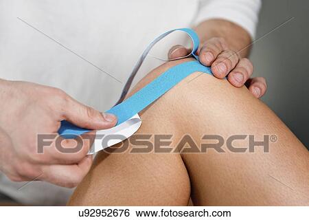 Stock Photograph - Kinesio tape application. Fotosearch