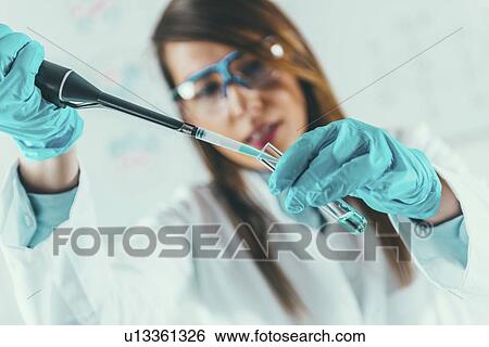 Laboratory technician using micropipette View Large Photo Image Stock Photograph - Laboratory technician using micropipette. Fotosearch