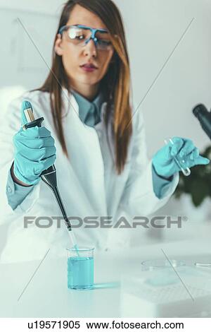 Laboratory technician with micropipette View Large Photo Image Stock Photography - Laboratory technician with micropipette. Fotosearch
