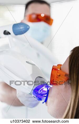 Stock Image - Laser teeth whitening procedure. Fotosearch