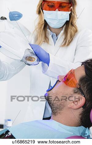 Laser teeth whitening View Large Photo Image Stock Photo - Laser teeth whitening. Fotosearch