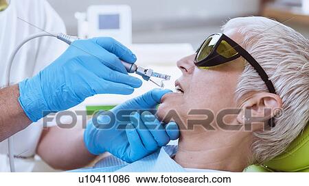 Stock Photograph - Laser teeth whitening. Fotosearch