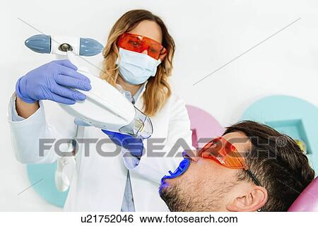 Stock Photograph - Laser teeth whitening. Fotosearch