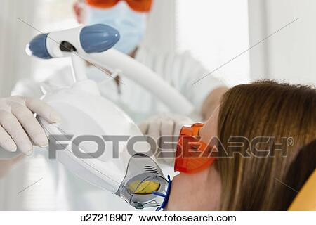Laser teeth whitening treatment View Large Photo Image Stock Photo - Laser teeth whitening treatment. Fotosearch
