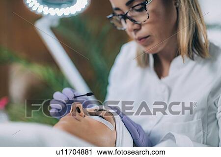 Stock Image - Lash lifting in beauty salon. Fotosearch