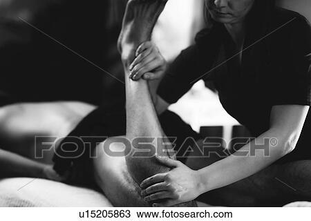 Stock Image - Leg massage. Fotosearch