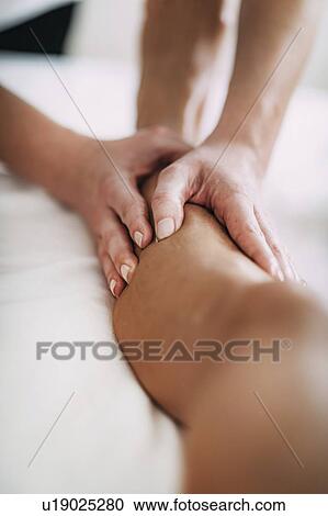 Stock Image - Leg massage. Fotosearch