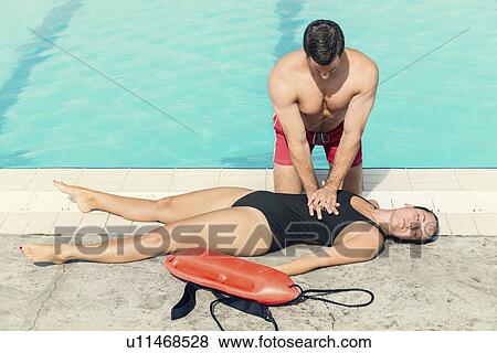 Stock Photo - Lifeguard doing CPR. Fotosearch
