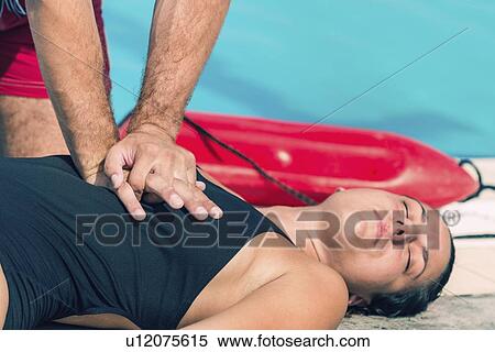 Lifeguard doing CPR View Large Photo Image Stock Photography - Lifeguard doing CPR. Fotosearch