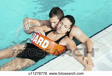 Stock Photo - Lifeguard helping young woman. Fotosearch